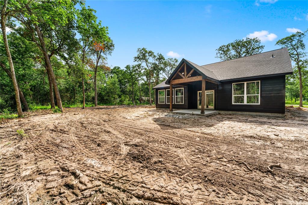 Covered back patio is nice and shaded with plenty of room for an outdoor living area.