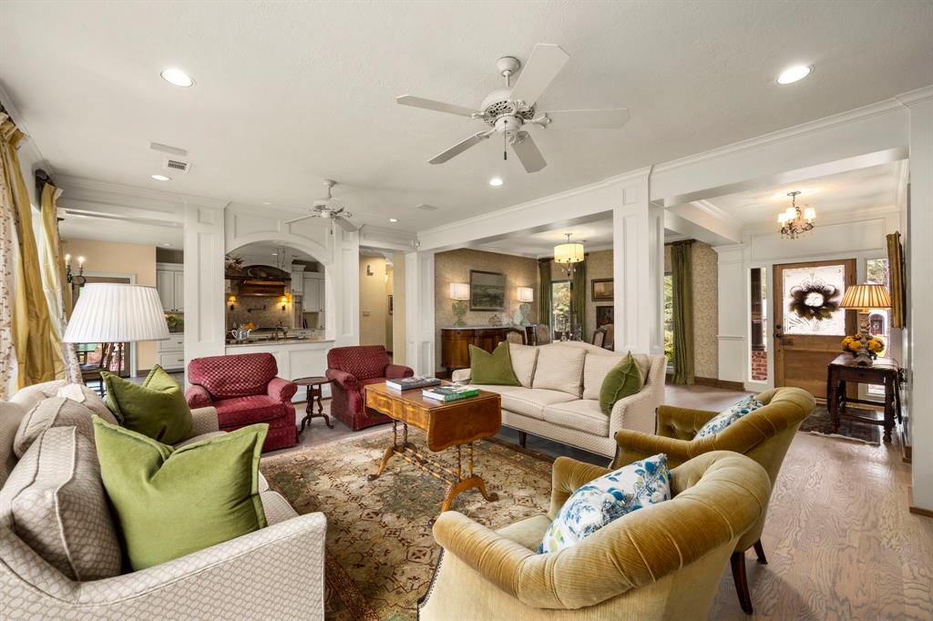 View from the living space looking towards the kitchen and front of the home. Elegant wood floors grace the 1st level, and the neutral colors and open space allow for almost any design style.  Simply beautiful the way it sits, but easily transitional.