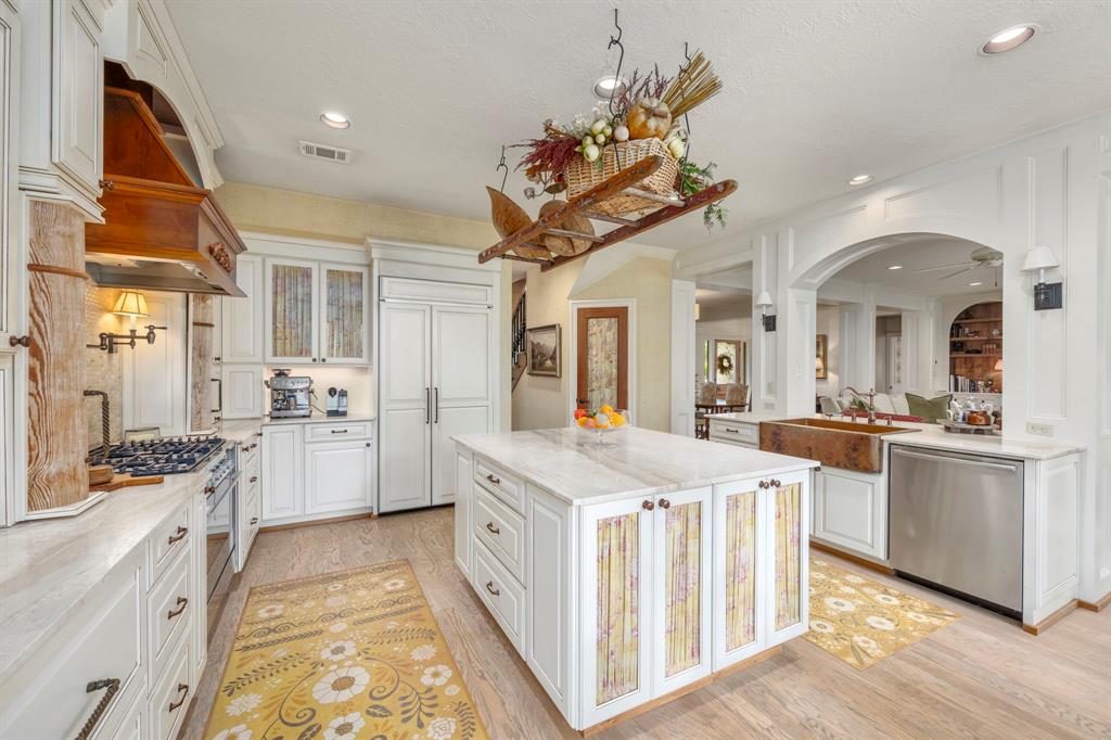 Enjoy cooking or entertaining in this bright light filled kitchen.  The oversize island provides for plenty of prep and serving space, additional storage, enjoy the step-in pantry, built-in refrigerator and open view to the gathering space.