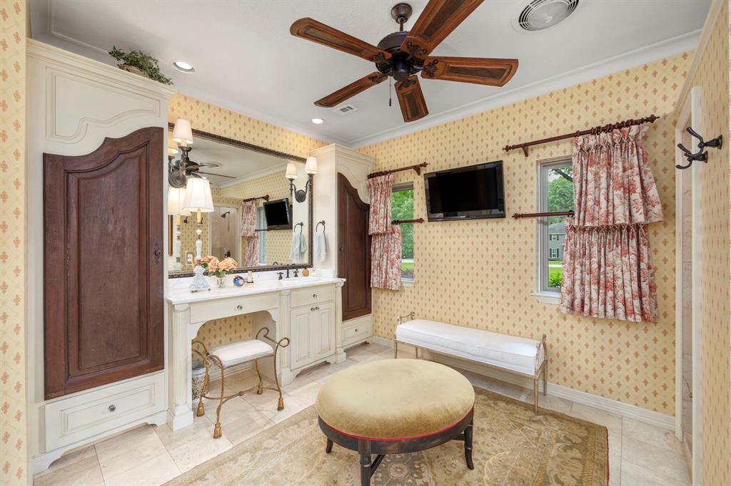 Primary bathroom vanity 2 with dressing area and generous storage area behind the vintage doors.