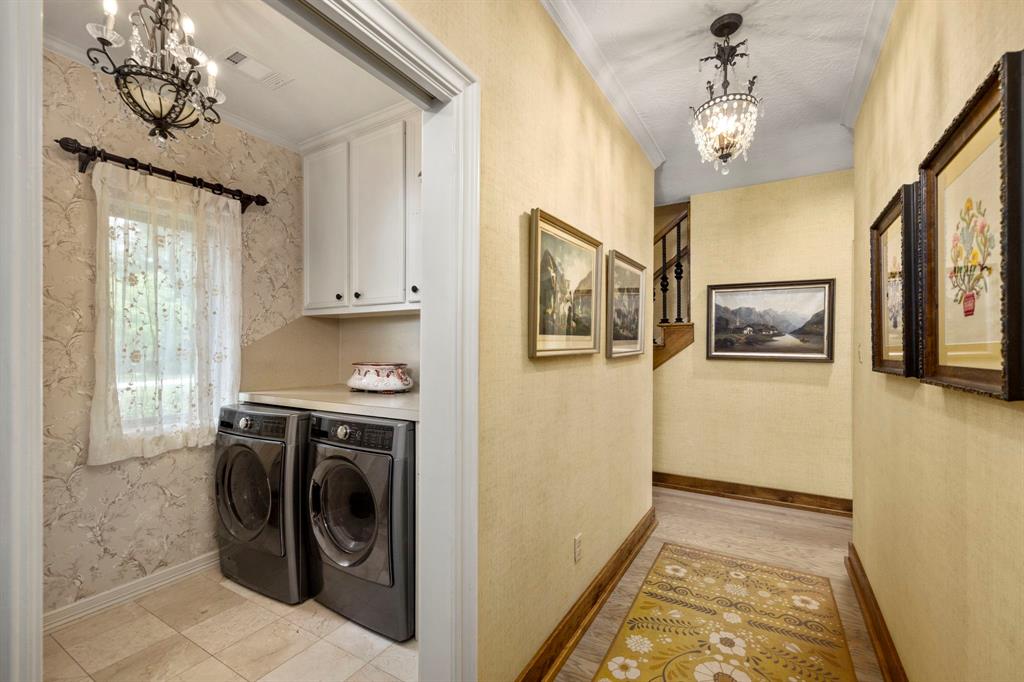 Simple yet very functional laundry room with folding ledge and storage above