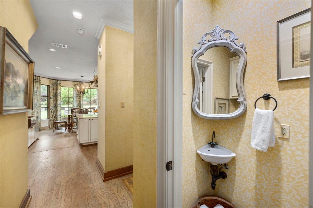 The powder/guest bath will surely be a conversation starter, in the best way!  This beautiful little space has a vintage corner sink adding personality to the space in addition to function.