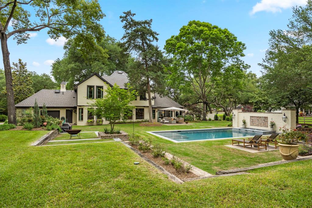 Sprawling multi-tiered backyard with spa-like pool, spa, lounge area, dining area and endless options for the grassy area...leave it green, great for pets, a play area or garden.