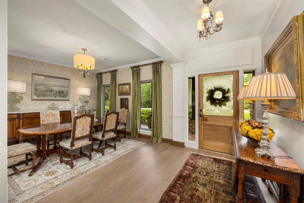 Inviting foyer with beautiful wood floors, neutral wall color and an abundance of natural light.