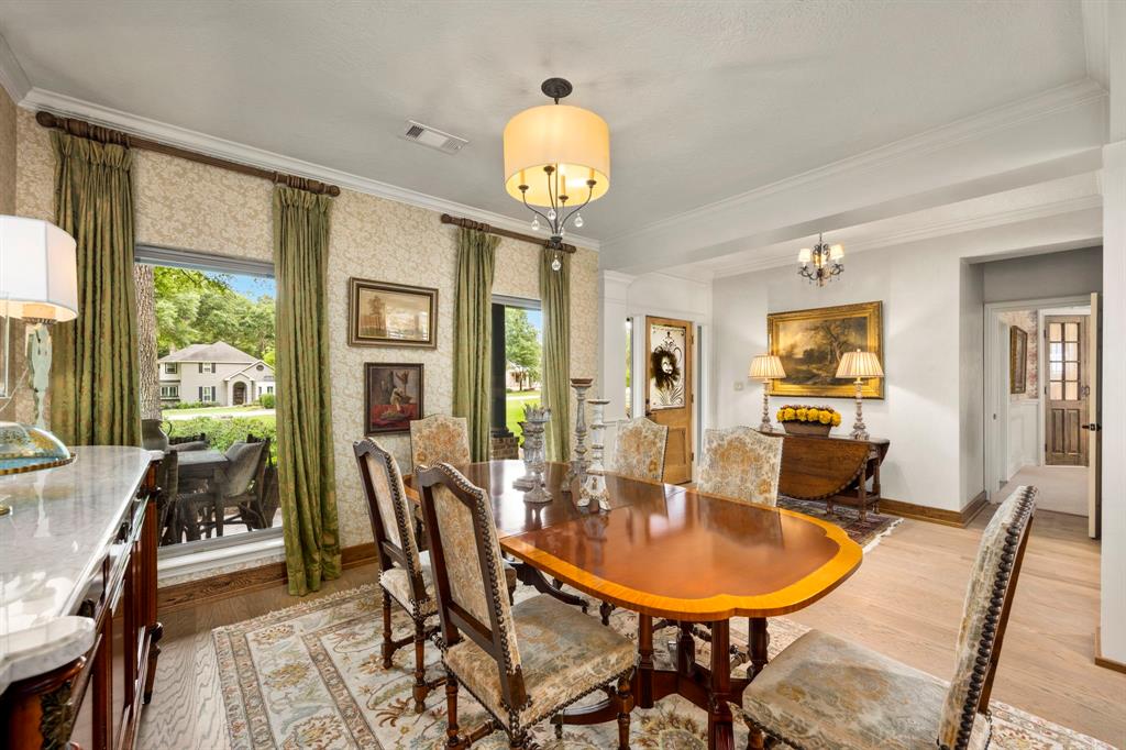 Formal dining space for up to 8, beautiful views of the front and back yard, open plan for ease in entertaining and conversation. Custom wallpaper and draperies add to the style and warmth of this room.