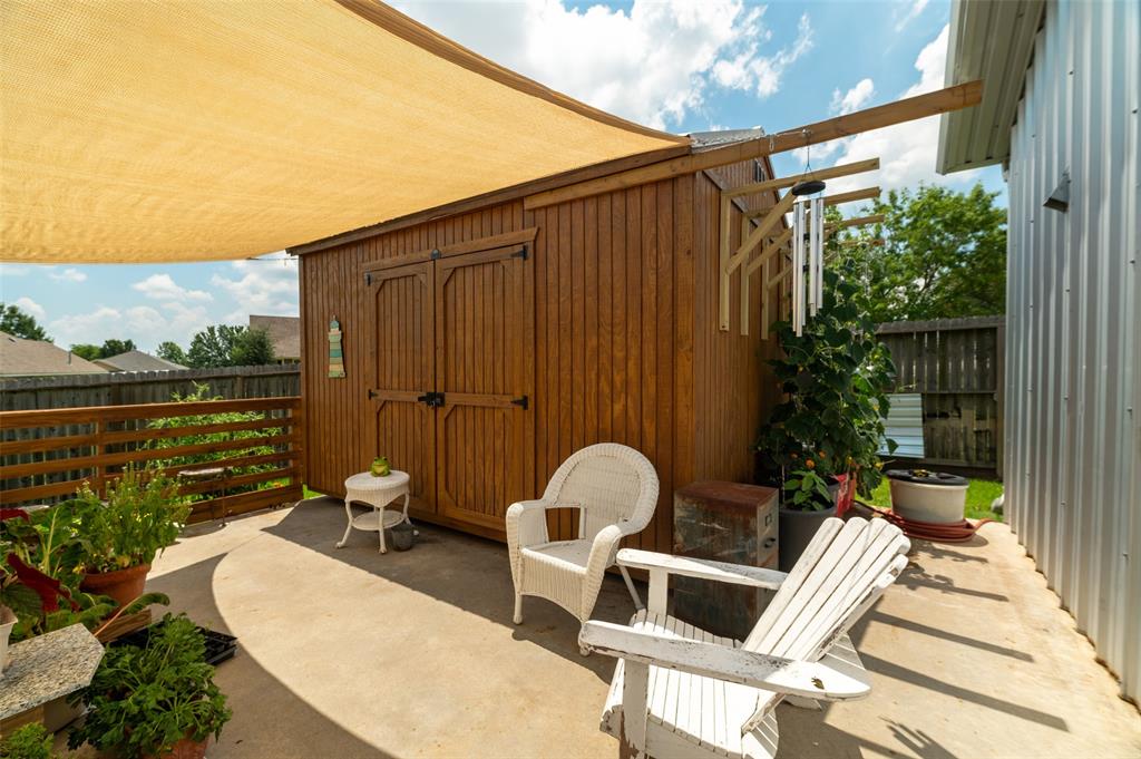 1610 N. Park St patio has a water hose bib on the side of the shed to keep those plants growing!