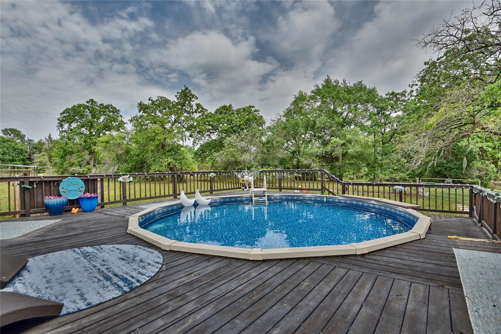 Love this huge raised deck for lounging around the semi-underground pool!