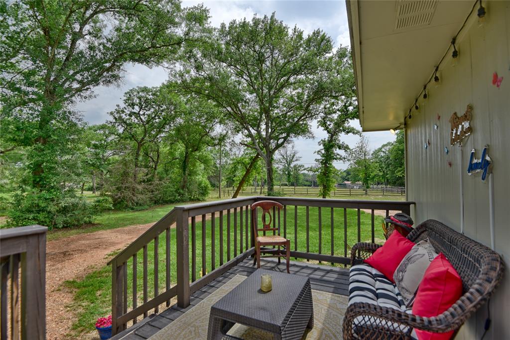 Another view of the cozy side porch for relaxing in a little more private setting.