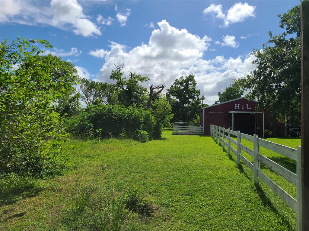 The property line runs along the fence line and wraps around the the side of the barn with the fencing on the side of the barn being on the subject property.