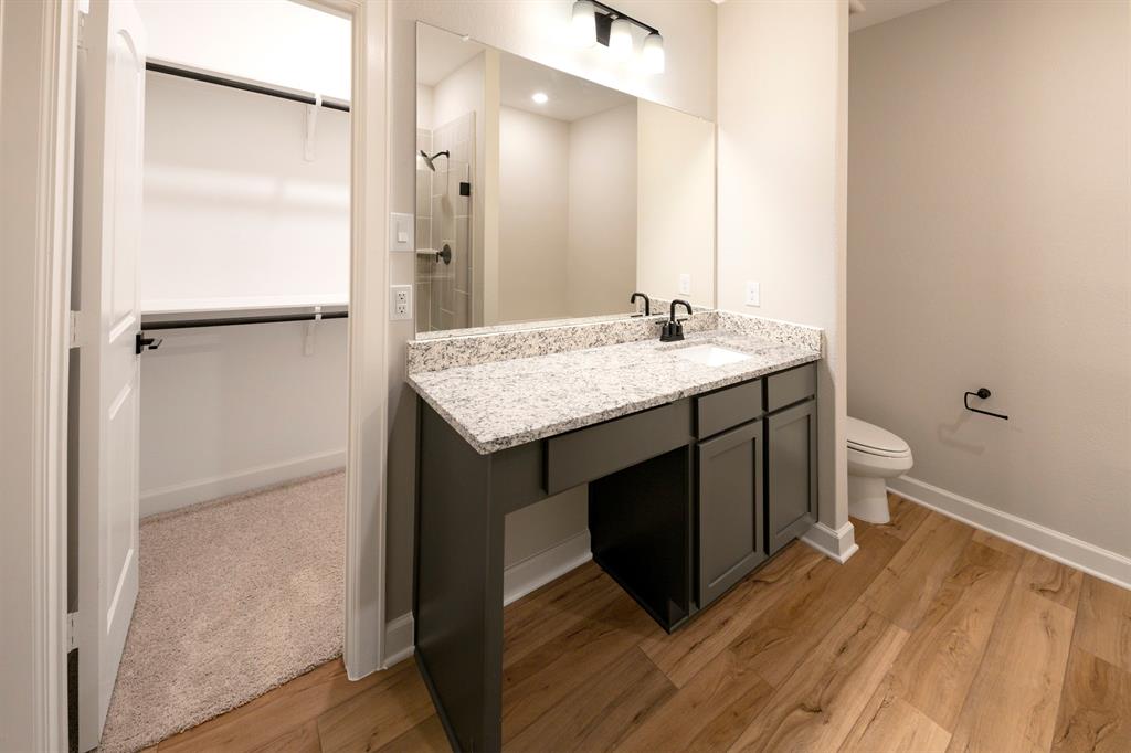 In the spacious bathroom, a modern vanity adds elegance and functionality.