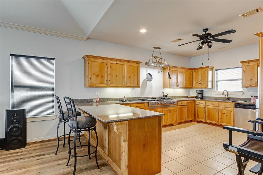 Huge breakfast bar with upgraded countertops and custom cabinetry, Pot rack and top of the line appliances!