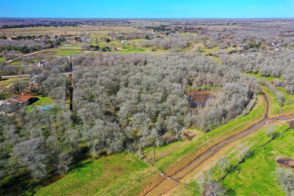 The expansive 5.2-acre property extends towards a picturesque creek