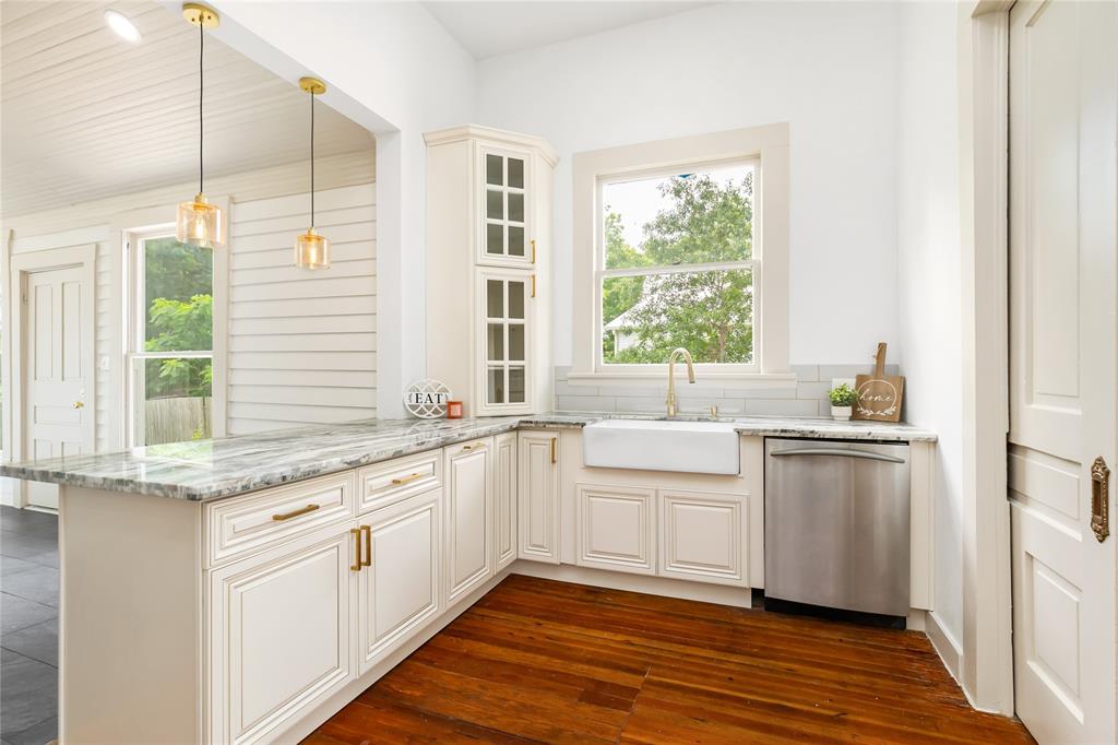 Kitchen with window looking at side of home