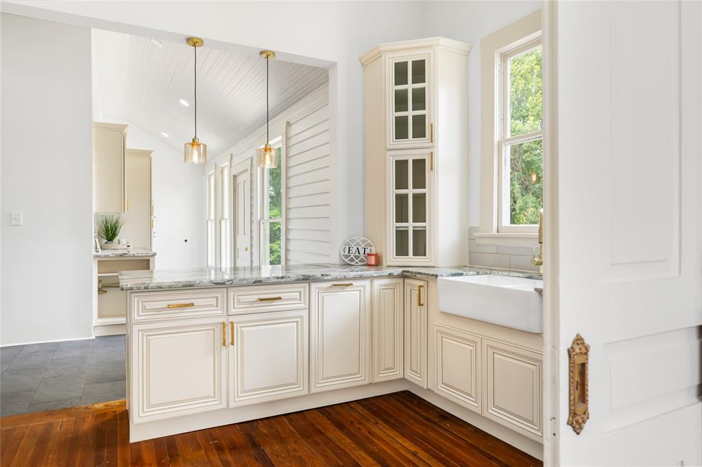 Kitchen with window looking at side of home