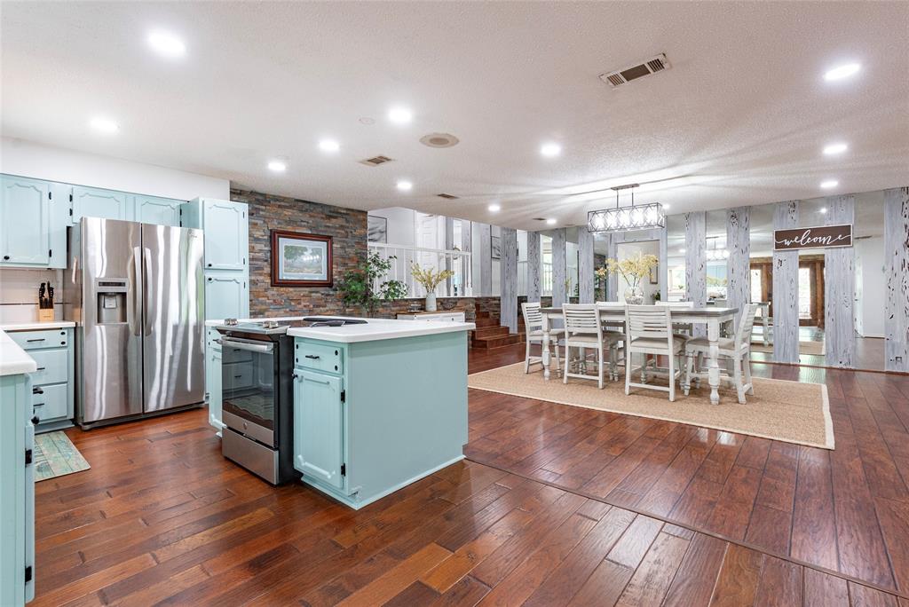 Updated kitchen with engineered wood floors and stainless steel appliances