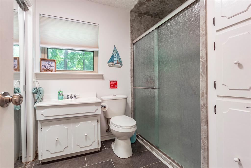 second full bath located in a hallway off the kitchen entry area