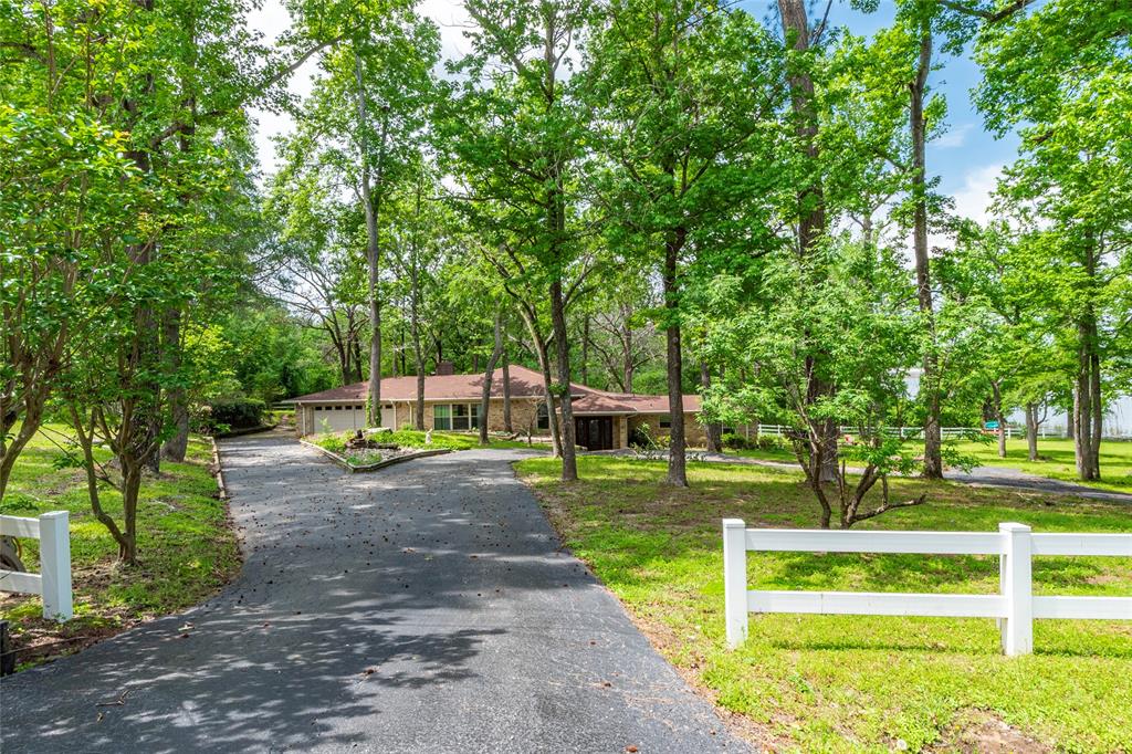 White country fence, circle driveway and gorgeous trees