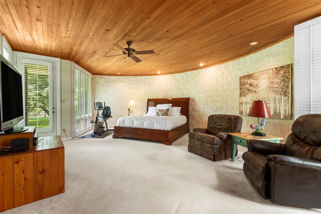 A wall of windows provides incredible views of the private back acreage. The French door leads to the back covered patio.