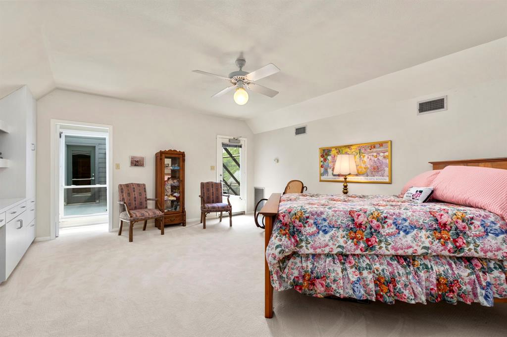 Another view of the second bedroom. French doors with shades leads to the hallway with a door to the screened porch.