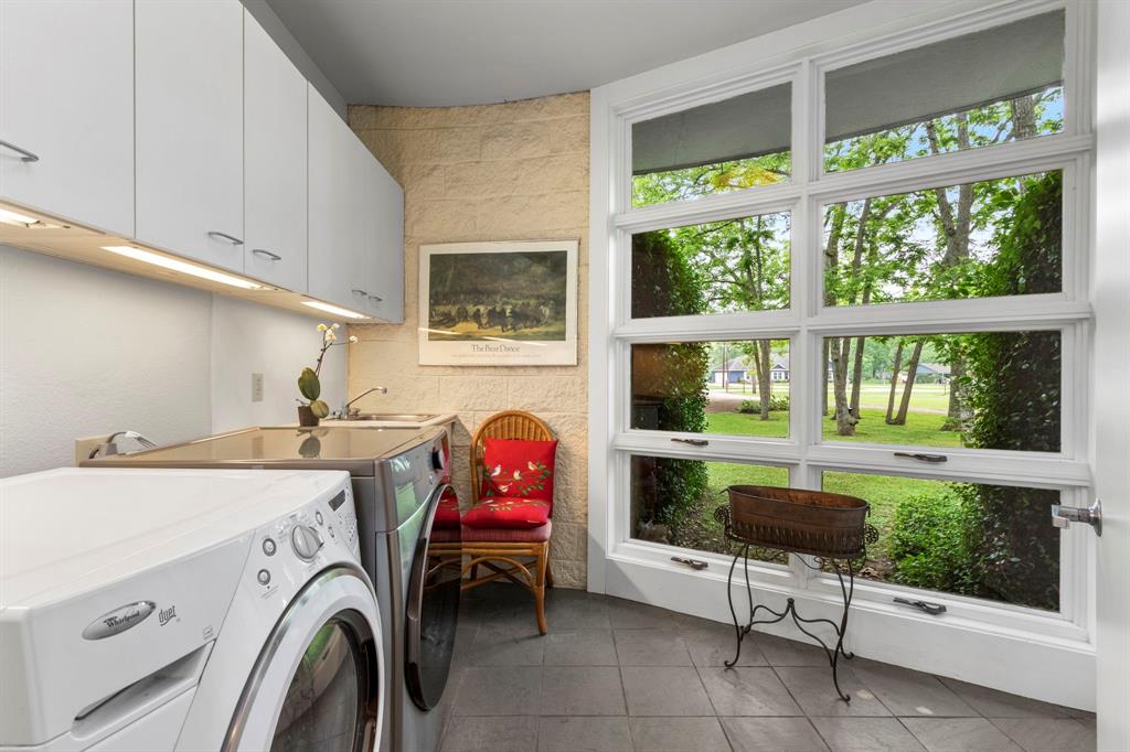 Laundry day will be a breeze. Ample cabinets with under mount lighting for storage and a sink.