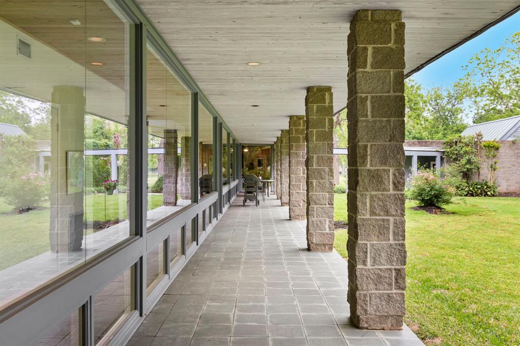 View from the primary suite french door of the 85 ft. long back patio. The perfect place to dine alfresco or just relax and unwind at the end of a busy day.