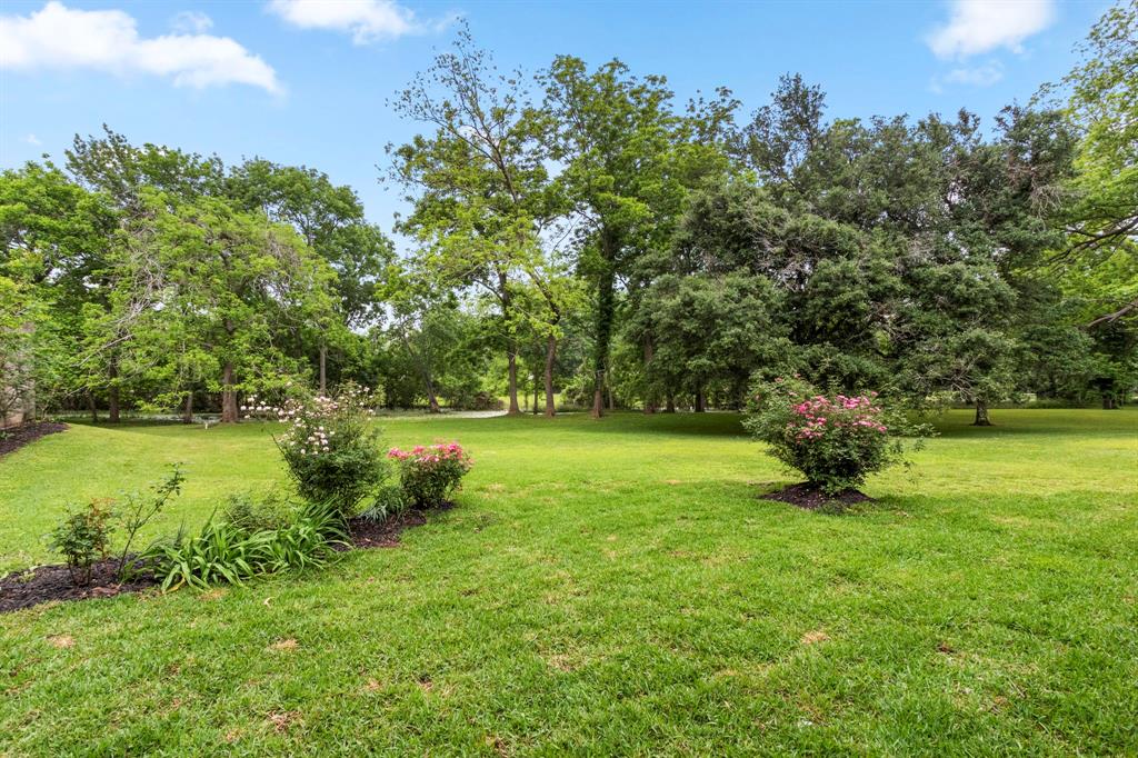 Incredible view from the back patio down to the lake. Room for a sparkling pool, garden and all your favorite outdoor activities. The owners had previously fenced off a pasture for their horses.