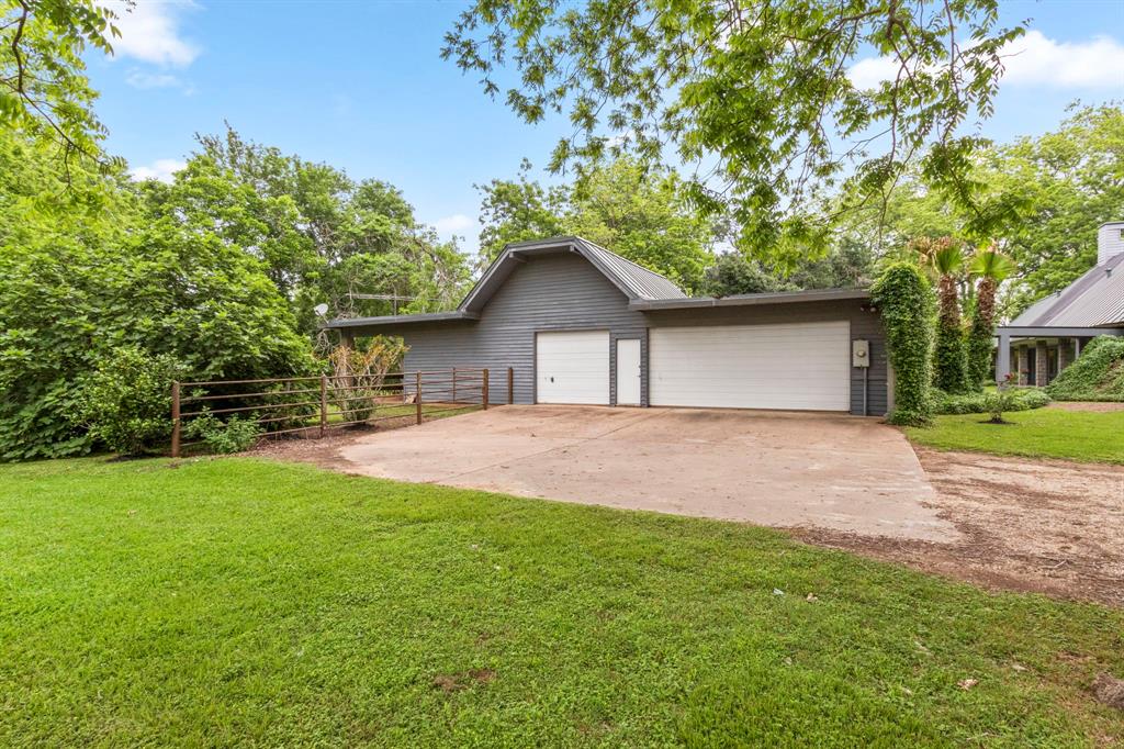 Oversized 3 car garage with workshop and overhead storage. The horse stable is located at the back of the garage.