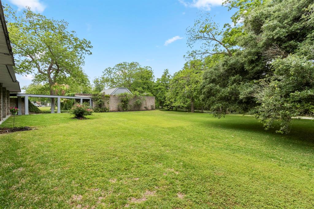 This view of the back yard shows the 3 car oversized garage and stable.