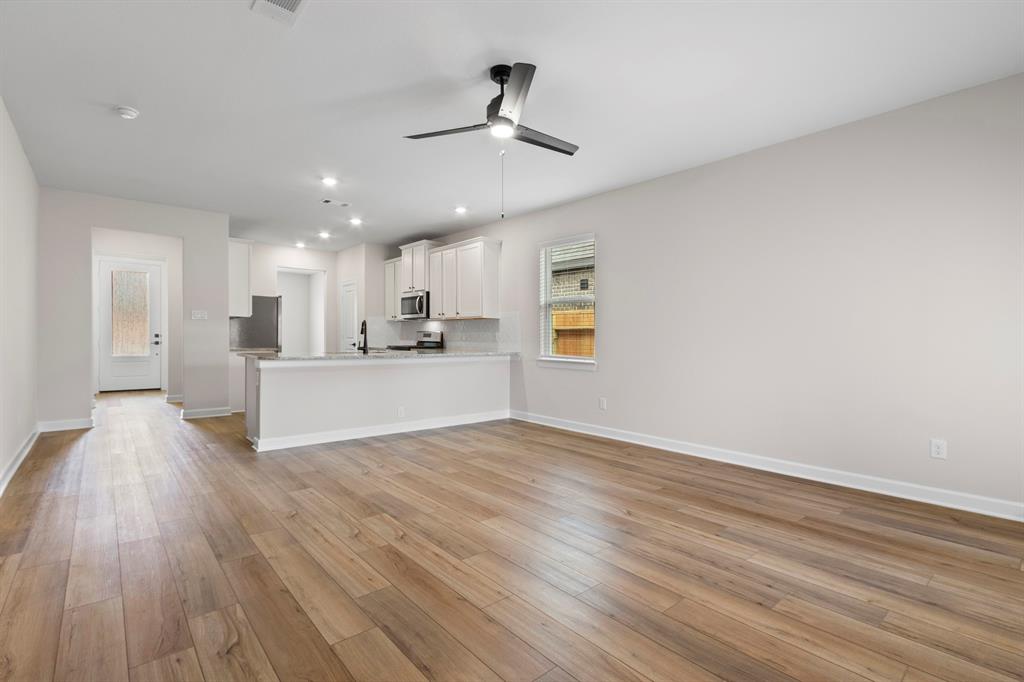 the spacious living room, open to the kitchen with access to the dining area.