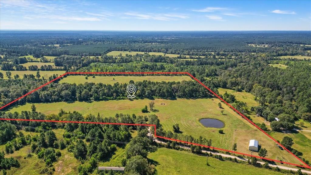 Welcome to the ranch or hunting paradise located near the Davy Crockett National Forest, Lufkin, and Lake Livingston! It is also within 2 hours of Houston/2.5 hours of Dallas. This BEAUTIFUL 39+ acres is ready for cattle or to build your dream home. It is completely fenced and cross fenced with steel T posts. It features 2 spring fed ponds, so they never go dry. The larger pond has been stocked with catfish.  There is a corral that was built for cattle. The property has a large 30X54 workshop equipped with electricity, water and septic.  That's 1620 square feet of space to store your RV, tractor, four-wheeler, etc.  A berm was also built for easy target practice.  Enjoy a low 1.2965 tax rate. There is currently an Ag/Timber Use Exemption which brings the yearly taxes to only $54/year. This property has multiple pecan trees and cedar trees as well.  Deer stand will convey with property. 
This is a must see to appreciate the beauty and serenity!