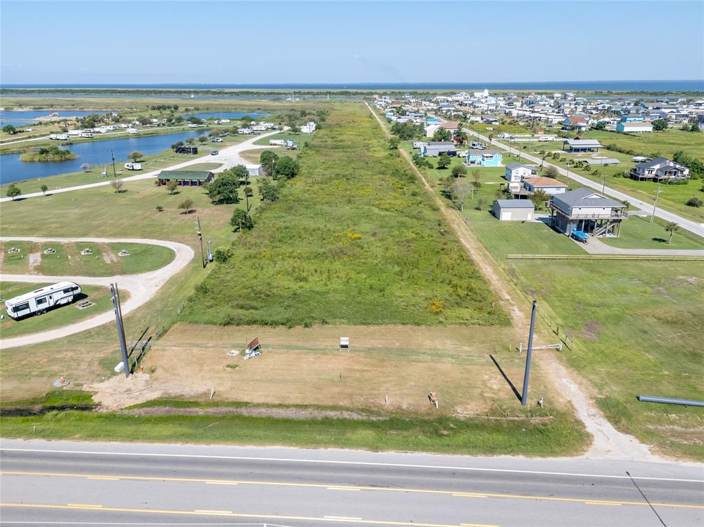 Unveiling a prime investment opportunity, this unique property boasts an impressive 2,800 ft of Intracoastal Canal frontage, complete with a barge dock and bulkhead, perfect for commercial or recreational use. Adjacent to the vibrant Texas Crab Festival grounds, this parcel features over 4,000 ft of rock road, ensuring seamless access throughout. Its unparalleled location, with beach access directly across Hwy 87, sets the stage for beach house development or a lucrative RV park. Unrestricted and versatile, this land is a rare gem with unmatched potential. Don’t miss your chance to transform this coastal haven into your next venture!