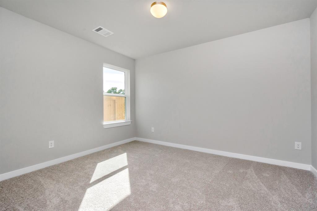 Generously sized secondary bedrooms featuring spacious closets, soft and inviting carpeting underfoot, large windows allowing plenty of natural light, and the added touch of privacy blinds for your personal retreat. Sample photo of completed home with similar floor plan. As-built interior colors and selections may vary.