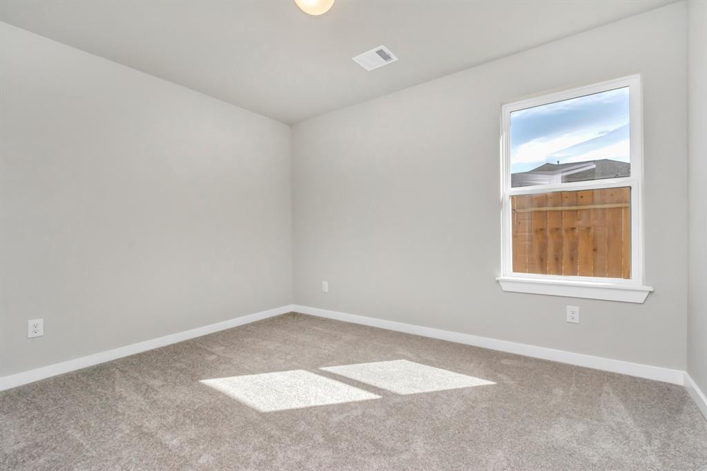 Generously sized secondary bedrooms featuring spacious closets, soft and inviting carpeting underfoot, large windows allowing plenty of natural light, and the added touch of privacy blinds for your personal retreat. Sample photo of completed home with similar floor plan. As-built interior colors and selections may vary.