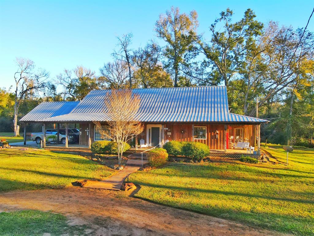 This beautiful 9-acre property offers a blend of timeless charm and natural beauty. The main house exudes the character of years gone by, with a classic farmhouse style, welcoming wrap around porches, and interior details that reflect its rich history. It sits among scattered hardwood trees, which provide shade and add to the peaceful, countryside atmosphere. A live creek meanders through the land, offering a soothing backdrop and enhancing the natural serenity of the property.
The guest house provides a private, cozy retreat for visitors featuring two comfortable bedrooms, one bathroom, and a living space with a small kitchen. This makes it perfect for family and friends to enjoy a comfortable stay.
A modest storage building, along with a lean to covering, is ideal for keeping tools, outdoor equipment, or seasonal items. 
Both homes have propane back up generators for continued service during outages.