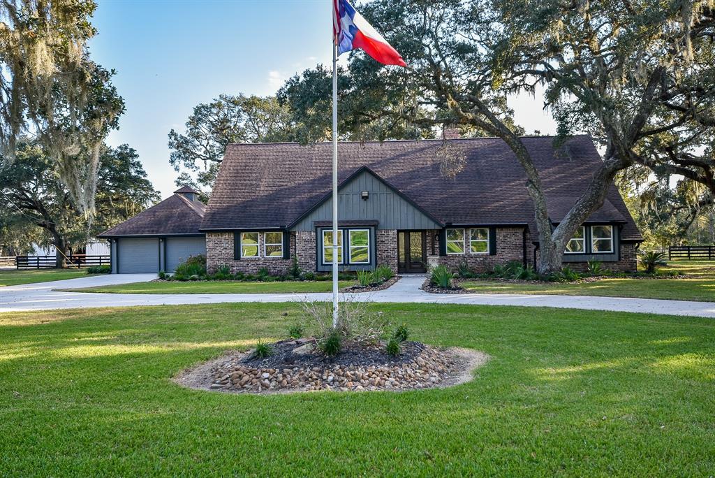 A home and property that says "Texas."  Sitting on just under 10 acres, the property features a main house, horse stable, fenced open and cleared land, and majestic oak trees.  The home is recently remodeled and features tile flooring, vaulted and coffered ceilings, ceiling fans, smoke detectors, wood molding and window framing, designer cabinets, recessed lighting and architectural lighting and fixtures.  An interior feature is a large, wood burning fireplace.  The kitchen is an entertainment delight complete with stainless steel appliances, commercial grade refrigerator, and a large island with sink.  A generous outdoor patio features a coffered ceiling, ceiling fans, recessed lighting, access to gas and water.  The stables feature 11 stalls, each with lighting and water.  Sliding doors offer access to fenced pastures.  A manager office complete with bath and a tackroom also are features.