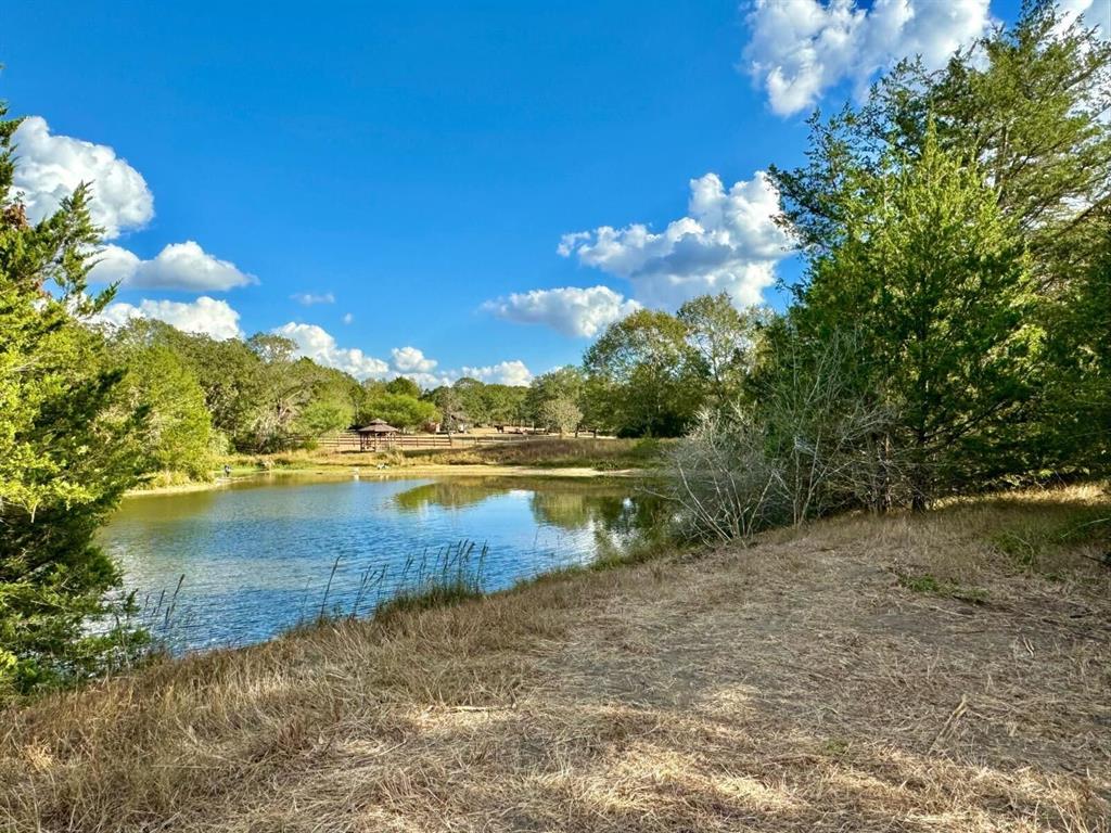 Highly sought after 5.6 acre tract close to the heart of Bellville! This rural tract offers so much that everyone wants with towering trees, trails and privacy at the end of a cul de sac! This tract has been strategically cleared and is now ready for new construction. Enjoy the serenity of this tract framed by nature providing an array of options like creating trails, fishing in the lake, or promoting wildlife. Perfect for creating your ideal hideaway. Light restrictions provide the freedom to build while preserving the charm and value of this sought-after area. Whether you envision a sprawling ranch home, modern farmhouse, or cozy countryside getaway, this property is a canvas waiting for your vision. Embrace the peace of rural living, just minutes from town. Additional lot connects to this one at 571 Oak Meadow, and is also available to be purchased together or separate.