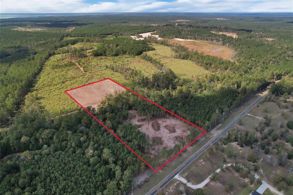 Gorgeous 11.2 acres off FM 350.  This area has rolling hills, tall pines and many barndos and beautiful custom homes.  Property does have light restrictions. The property has been cleared some in the front and back.