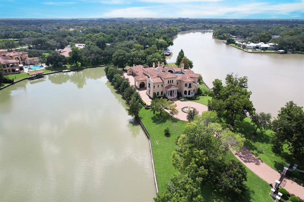 A world-class architectural masterpiece situated on one of the rarest & most incredible waterfront lots! Inspired by Europe's great estates, this pristine 2.13-acre property has incredible water views on 3 sides & is graced by mature trees & an oversized infinity pool lined w/tile from Italy. Grand yet intimate, the estate was designed by Robert Dame & built by Chris Sims. No detail was spared in its creation, w/master craftsmanship & unequivocal quality. 11 Paradise Point is in a class of its own. The 13,000 sqft interior offers endless lifestyle opportunities w/6 generous-sized suites, opulent formals for entertaining, a gorgeous kitchen, wellness gym, two game rooms, wet bars, media room & other entertainment amenities. Endless water views w/multiple balconies & terraces, outdoor living spaces, and outdoor fireplace & kitchen. Minutes to major freeways & 15 minutes from the Galleria. The gated community of Paradise Point is Sugar Land's best-kept secret.