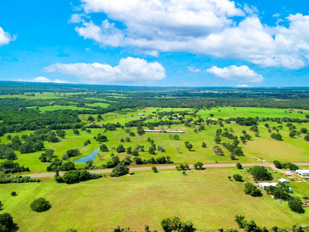 Located just west of HWY 304 with nearly half a mile of Old Highway 90 frontage, this 77-acre property in Gonzales County offers a great location. Austin and San Antonio are both just 1 hour . The rolling terrain features deep sandy soils and large Live Oaks and Post Oaks. The property includes a mix of open pasture and a large stock tank. Sandy Fork creek runs along the West boundary of the property. The property is improved with a hunters cabin, barns, electricity, and a water well. The historical “Old Spanish Trail” is the northern property boundary and may be ideal for artifact hunting. The property has a water meter with Gonzales County Water supply. This ranch would make a great homestead, weekend retreat, hunting camp, or cattle operation. Seguin, Lockhart, Gonzales, Bastrop and Smithville are all nearby.  Minutes to interstate 10 for excellent access.