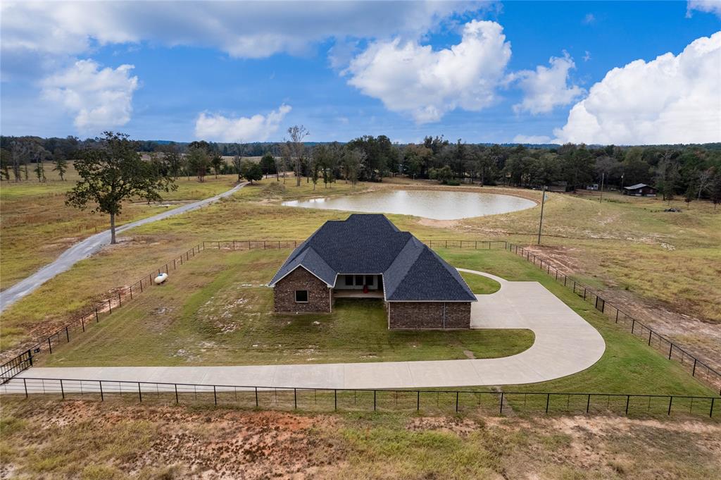 Super clean 3bed 2 bath home on just less than 20 acres completely fenced. Home has a modern design. House is equipped with a generator plug to plug in a generator in case of a power failure. Fenced yard with concrete driveway. House sits on top of a hill almost in the middle of the property over looking a freshly dug pond. Property is ready for horses or cattle and has a almost new barn designed around horses. Don't let this property slip though your hands. Buyers agents welcomed.