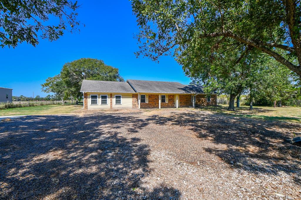 Welcome to your dream ranch-style retreat in Needville, TX! Nestled on a Pecan tree-adorned THREE ACRE tract, this charming farmstead offers 2,280 sq ft of beautifully crafted living space, complete with 4 bedrooms and 2 3/4 bathrooms. The heart of the home is the spacious farmhouse kitchen, featuring a breakfast bar and an open-concept design that flows effortlessly into the family room—perfect for everyday living and entertaining. Step outside to enjoy serene country views. Plus, you'll love the added convenience of extra parking or workspace. Two additional acres behind the home with a huge barn/workshop with lots of power! Don’t miss out on this rare opportunity—schedule your private tour today!