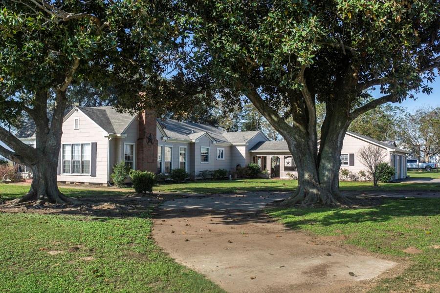 This expansive 344.45-acre farm boasts two homes, numerous barns, sheds, and grain bins (not currently in use). The main home, constructed in 1945, offers 3 bedrooms, 1.5 baths, a living room, formal dining room, kitchen and breakfast area, office, sunroom, covered breezeway, and a two-car garage. The second home, built in the 1940s and currently rented out, features a kitchen, living room, bedroom, bathroom, and flex room. Both homes include RV barns/carports with hookups. Additionally, the property offers a boat stall and multiple outbuildings. Embrace the serene surroundings and versatile living arrangements on this charming estate.