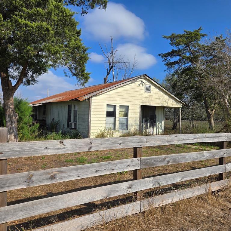 Headed out west? Explore this sprawling 4-acre county acreage just 5 minutes from charming, historic Yorktown, TX.  Listed AS-IS, this property has potential to become your dream. Enjoy the peace of mind of being out of the flood zone and city limits. The property has 2 metal buildings and a home that are not occupiable in their current state. Located just 45 minutes northwest of Victoria and 2 1/2 hours southwest of Houston.