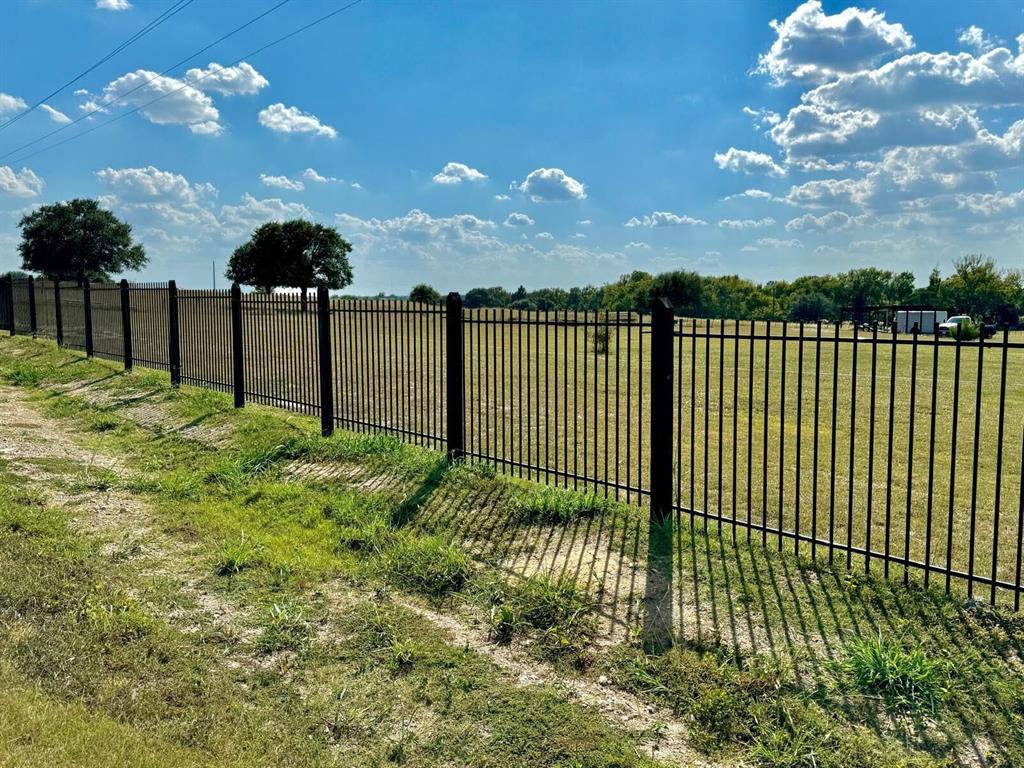 Rare and hard to find 5 acre tract close to Brenham with nice road frontage! This land is located within 5 min. of Brenham downtown, schools and shopping. This owner has installed a wrought iron fence along the road, driveway access and a two car carport has begun. Also, there is electric and water at the road eliminating the need for a well. Along the back is a wet weather creek! No flooding on this property. Survey available and Preliminary plat showing the division option into a 3 and 2 acre tract. Light restrictions for property value protection. No mobile homes allowed.