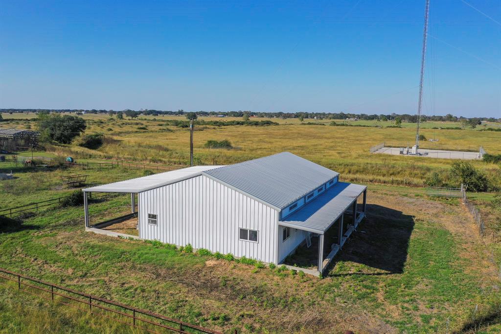 This 36.14-acre property offers a rare opportunity to customize your dream barndominium and operate a turnkey cattle or horse ranch. The barndominium is partially completed, with framing and 8-inch C Pearling flooring in place, ready for your personal touch to finish it out. A beautiful front and back porch provides relaxing spaces to enjoy nature, while the future kitchen is designed to overlook the back pasture, loafing shed, and livestock pens, offering scenic views. The property features welded pipe fencing and numerous improvements, providing a solid foundation for a fully operational ranch. A creek runs through the land and the property is located outside the floodplain. This property is perfectly set up for ranch life, with ample space for livestock and plenty of potential to make it your own. Enjoy scenic vistas and ample room to create your perfect space.