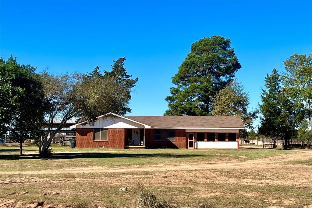 CALLING ALL HORSE LOVERS!  This 20-acre property complete with a 2 bed, 1 bath brick home and a massive 3,150 square-foot horse barn and arena has everything you need to own your dream horse ranch.  Nestled on the outskirts of Grapeland, this property is a slice of country paradise.  The main home features a brand new screened-in front porch, as well as an open-concept living space with a large kitchen island.  The most noticeable feature of this beautiful property is an impressive horse barn behind the home, complete with tack room, large arena, and multiple horse stalls.  The 20 acres are cross-fenced, making it the perfect place for all of your livestock needs.  If you've been looking for a quaint home in the country to raise animals and enjoy the open range, look no further!