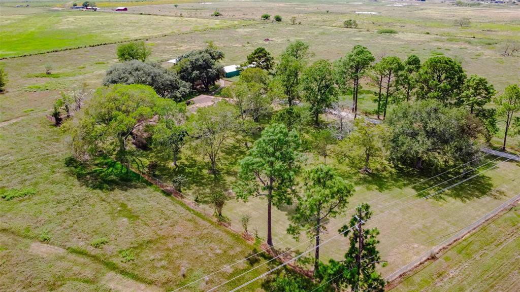 Spacious ranch style home on 5 acres with 275' of frontage road on Highway 36. Property has no restrictions and can be used for commercial or residential purpose. Tons of possibilities with the home offering 3 bedrooms, 2.5 baths and an additional game room with 1 full  bathroom accessed through the garage. Fenced yard, paved driveway, mature trees and two barns. One barn offers 5 bays and the other has an attached, covered shed. Low tax rate and easy access to major thoroughfares. Ag exemption currently in place for Hay lease.