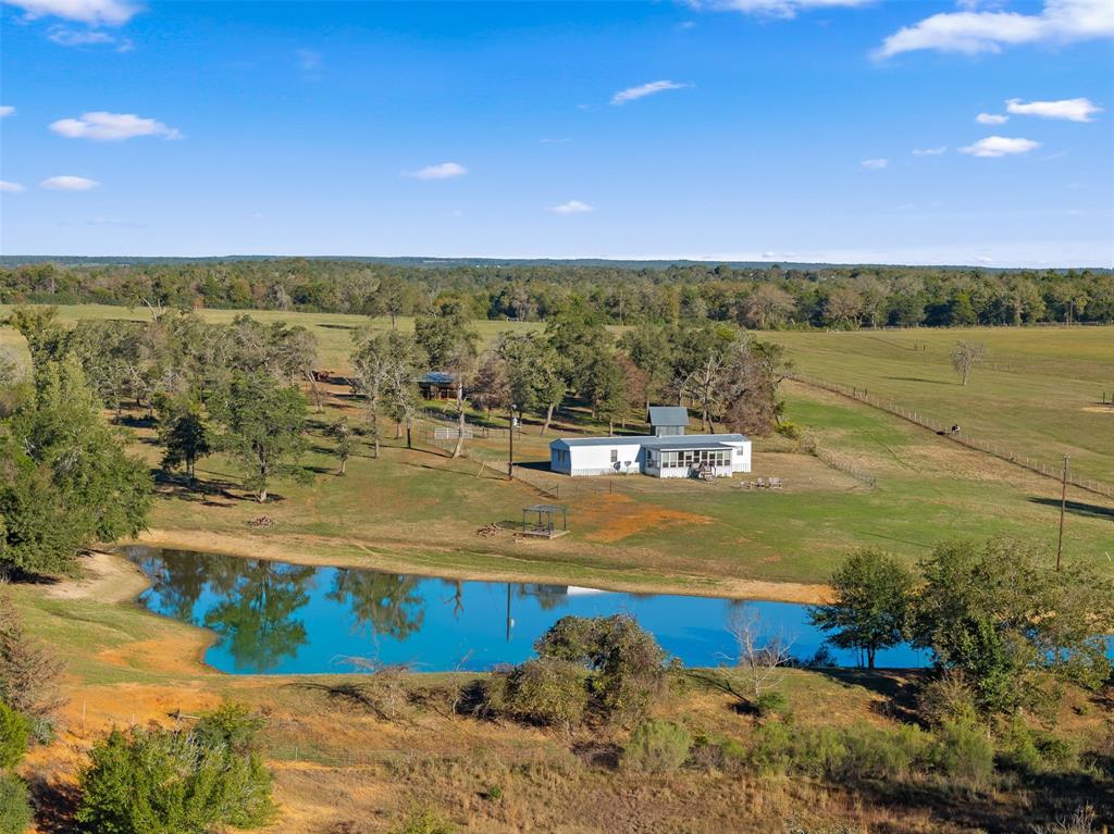 Discover the beauty of country living on this stunning 26.54-acre property located in Burleson County. The property is equipped with a furnished mobile home featuring three bedrooms two bathrooms and an enclosed porch, offering a comfortable and inviting space. The property includes a horse barn with three stalls and a paddock. Enjoy serene outdoor living on the spacious deck that overlooks a large pond. SW Milam water meter on site provides water to the property. Previously used for a yearling cattle operation, this land is well-suited for agricultural activities and is rich in wildlife, making it perfect for nature enthusiasts and hunters alike. Conveniently situated between Caldwell, Rockdale and Lexington this property combines the tranquility of rural life with easy access to local amenities. Don't miss out on this exceptional opportunity! Just under 1 hour to College Station, Taylor or Bastrop.