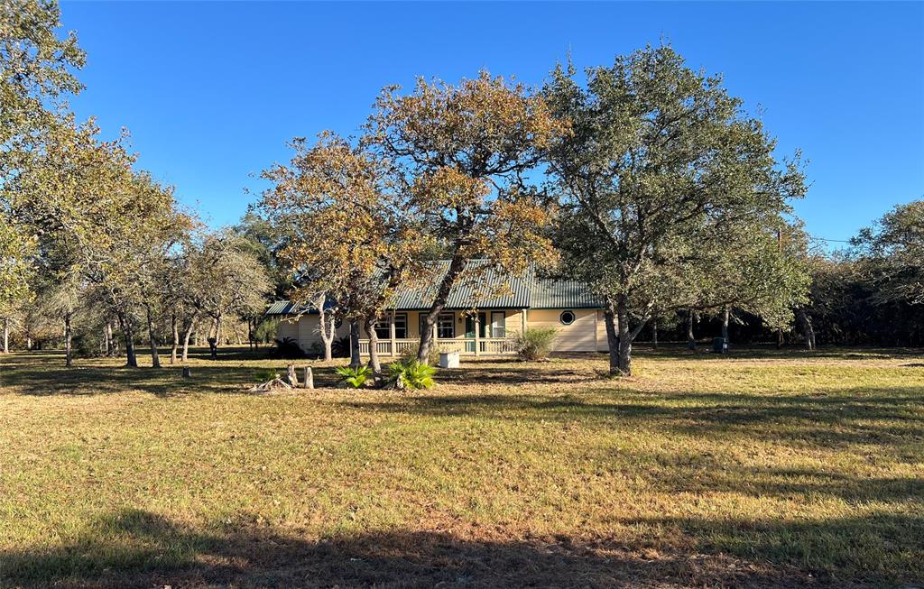 Welcome to 1003 Reeves Road, a charming home situated on 5.20 acres of peaceful countryside. This  2-bedroom, 2-bathroom home offers 1,302 square feet of living space, perfect for those seeking comfort and tranquility. The spacious family room features built-in bookshelves, a vaulted ceiling with soaring beams, and an open-concept design, creating a bright and welcoming atmosphere. A unique double-sided fireplace connects the family room to the primary bedroom, adding warmth and character. In the primary bath, enjoy relaxing moments in the jetted tub under the elegant glow of a beautiful chandelier. The home has been updated with new flooring throughout. Outdoors, you'll find a 20x16 metal storage building/workshop with a roll-up door, ideal for storage or hobbies. A peaceful pond at the back of the property provides a serene spot for fishing or simply enjoying the view. This property offers the best of country living with all the comforts of home! Call today to schedule your showing!