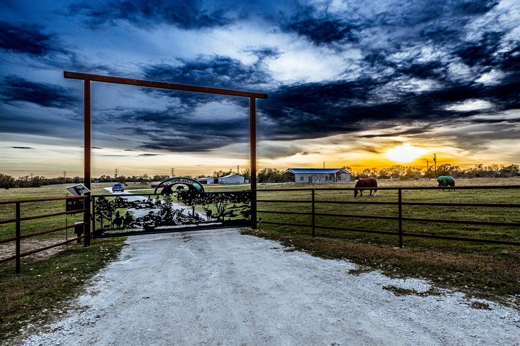 Welcome to this exceptional 11-acre property in North Zulch. Built in 2023, the beautifully designed 1,860-square-foot home is an entertainer's dream, featuring an open-concept floor plan with a seamless flow from indoors to out. Step outside to the stunning backyard oasis, where you'll find a sparkling pool with built-in fire pit accents, a tanning deck, and a full outdoor bar, perfect for hosting guests and enjoying year-round relaxation. The kitchen window opens directly to the outdoor space, creating an easy connection between interior and exterior, making entertaining effortless. The property also boasts a barn with horse stalls, ideal for equestrian enthusiasts or those seeking additional storage. The custom automatic front gate provides both privacy and a grand entrance to the property. Located just 12 miles from Madisonville and 35 miles from College Station, this home offers the peace and privacy of rural living while still being conveniently close to local amenities.